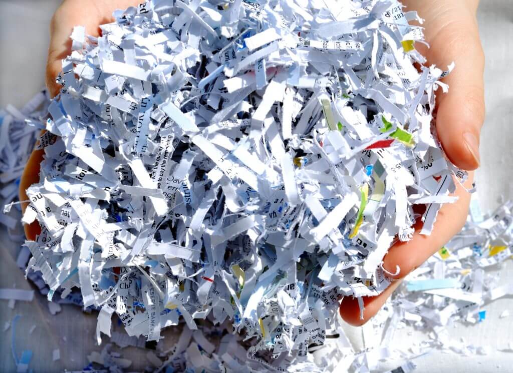 person holding shredded document